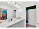 Bright bathroom with double sinks, white countertops, and a doorway to a themed bedroom at 1615 Sanibel Dr, Davenport, FL 33896