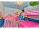 Unique bedroom featuring a whimsical theme, castle murals, and fun decor for a playful atmosphere at 1615 Sanibel Dr, Davenport, FL 33896