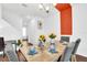 Bright dining room featuring hardwood floors, modern lighting, and a stylish table setting for an inviting atmosphere at 1615 Sanibel Dr, Davenport, FL 33896