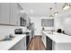 Modern kitchen equipped with stainless steel appliances, ample counter space, and sleek gray cabinetry at 1615 Sanibel Dr, Davenport, FL 33896