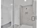 Contemporary glass shower with marble tile, enhancing the bathroom's elegance and providing a spa-like experience at 1615 Sanibel Dr, Davenport, FL 33896