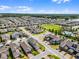 Expansive aerial view of a community featuring a large park, pool, and well-maintained landscaping at 16484 Angel Fish Rd, Winter Garden, FL 34787