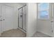 Clean bathroom showcasing a glass-enclosed shower, neutral tile, and a bright window at 16484 Angel Fish Rd, Winter Garden, FL 34787