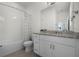 Neutral bathroom with granite vanity, modern hardware, and tub with shower at 16484 Angel Fish Rd, Winter Garden, FL 34787