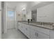 Elegant bathroom features double vanities, granite countertops, and modern fixtures at 16484 Angel Fish Rd, Winter Garden, FL 34787
