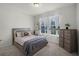 Bright bedroom features neutral walls, plush carpeting, and a large window at 16484 Angel Fish Rd, Winter Garden, FL 34787