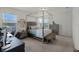 Bright bedroom featuring a four-poster bed, neutral decor, and large windows for plenty of natural light at 16484 Angel Fish Rd, Winter Garden, FL 34787