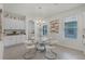 Bright dining area with a modern glass table, stylish chairs, and ample natural light at 16484 Angel Fish Rd, Winter Garden, FL 34787