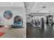 Dual view of the fitness center with modern equipment and a room with play area and themed decor at 16484 Angel Fish Rd, Winter Garden, FL 34787