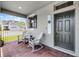 Inviting covered front porch with brick flooring and rocking chairs creating a relaxing outdoor space at 16484 Angel Fish Rd, Winter Garden, FL 34787