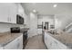 Stylish kitchen with stainless steel appliances, granite countertops, and white cabinets for a clean, modern look at 16484 Angel Fish Rd, Winter Garden, FL 34787