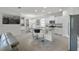 Modern kitchen with white cabinetry, granite countertops, stainless steel appliances, and a breakfast bar at 16484 Angel Fish Rd, Winter Garden, FL 34787
