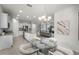Bright eat-in kitchen features stainless appliances, island, and glass dining table at 16484 Angel Fish Rd, Winter Garden, FL 34787