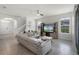 Open-concept living room with modern furniture, tile flooring, and ample natural light at 16484 Angel Fish Rd, Winter Garden, FL 34787