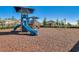 Community playground with slides, climbing structures, and swings set in a safe, mulched area at 16484 Angel Fish Rd, Winter Garden, FL 34787