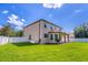 Expansive backyard with lush green grass, privacy fence, and covered patio, offering ample space for outdoor activities at 1676 Song Sparrow Ct, Sanford, FL 32773