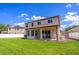 Backyard featuring a large green lawn, shed, and covered patio at 1676 Song Sparrow Ct, Sanford, FL 32773