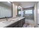 Bright bathroom featuring double vanity with a gray countertop, modern fixtures, and a tub and shower combination at 1676 Song Sparrow Ct, Sanford, FL 32773