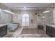 Bright bathroom features free standing tub and frameless shower at 1676 Song Sparrow Ct, Sanford, FL 32773