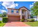 Charming two-story home featuring a brick driveway, two car garage and manicured landscaping at 1676 Song Sparrow Ct, Sanford, FL 32773
