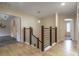 Upstairs hallway with modern railings and plank flooring at 1676 Song Sparrow Ct, Sanford, FL 32773