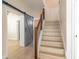 Hallway with stairs, wood floors and gray barn doors at 1676 Song Sparrow Ct, Sanford, FL 32773