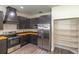 Well-equipped kitchen boasts stainless appliances, dark cabinetry, wood counters, and large pantry at 1676 Song Sparrow Ct, Sanford, FL 32773