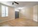 Bright living room with wood floors, gray doors, a ceiling fan and natural light at 1676 Song Sparrow Ct, Sanford, FL 32773