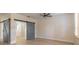 Bright living room with wood floors, gray doors, a ceiling fan and natural light at 1676 Song Sparrow Ct, Sanford, FL 32773