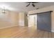 Bright living room with wood floors, gray doors, a ceiling fan and natural light at 1676 Song Sparrow Ct, Sanford, FL 32773