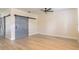 Bright living room with wood floors, gray doors, a ceiling fan and natural light at 1676 Song Sparrow Ct, Sanford, FL 32773