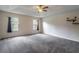 Spacious main bedroom featuring tray ceilings, neutral paint, and plush carpeting at 1676 Song Sparrow Ct, Sanford, FL 32773
