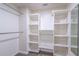 Walk-in closet featuring white shelving and clothing rod at 1676 Song Sparrow Ct, Sanford, FL 32773