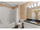 Bright bathroom with tiled shower/tub, black granite vanity, and dark wood floors at 1979 Summer Club Dr # 115, Oviedo, FL 32765