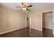 Bedroom with wood floors, open closet and en-suite bathroom at 1979 Summer Club Dr # 115, Oviedo, FL 32765