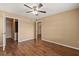 Bedroom featuring wood floors, ceiling fan, walk-in closet and en-suite bathroom at 1979 Summer Club Dr # 115, Oviedo, FL 32765