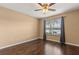 Neutral bedroom with window and wood floors, illuminated by a ceiling fan at 1979 Summer Club Dr # 115, Oviedo, FL 32765