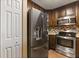 Updated kitchen features stainless steel appliances, a tile backsplash, and wood cabinetry at 1979 Summer Club Dr # 115, Oviedo, FL 32765