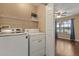 A laundry room with a washer and dryer next to a bedroom at 1979 Summer Club Dr # 115, Oviedo, FL 32765
