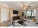 Cozy living room with a ceiling fan, sliding glass doors, a TV, and stylish furnishings at 1979 Summer Club Dr # 115, Oviedo, FL 32765