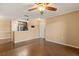 Open living room with wood floors, neutral paint, and a ceiling fan flows into kitchen at 1979 Summer Club Dr # 115, Oviedo, FL 32765