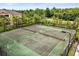 Aerial view of the community tennis courts, surrounded by lush tropical landscaping at 1979 Summer Club Dr # 115, Oviedo, FL 32765
