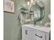 A stylish bathroom features a white vanity with a vessel sink, modern fixtures, and decorative elements at 2039 Beachberry Ln, Oviedo, FL 32765