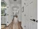 Inviting hallway with wood-look floors leading to bathroom and living area at 2039 Beachberry Ln, Oviedo, FL 32765