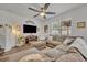 Cozy living room with a large sectional sofa, modern fireplace, and ambient lighting at 2039 Beachberry Ln, Oviedo, FL 32765
