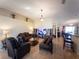 Spacious living room featuring tile flooring, a large decorative ledge, and comfortable seating at 212 Ashford Dr, Davenport, FL 33837