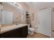 Cozy powder room features a modern sink, toilet, and stylish decorations on the shelves and wall at 2330 Little Gem Loop, Sanford, FL 32773