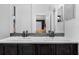 Modern bathroom featuring dual sinks, stylish mirrors, and a neutral color palette at 2330 Little Gem Loop, Sanford, FL 32773