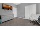 A cozy bedroom featuring a grey dresser, carpeted flooring and a TV mounted to the wall at 2330 Little Gem Loop, Sanford, FL 32773