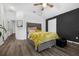 A cozy bedroom featuring wood floors, a comfortable bed, and accent lighting at 2330 Little Gem Loop, Sanford, FL 32773